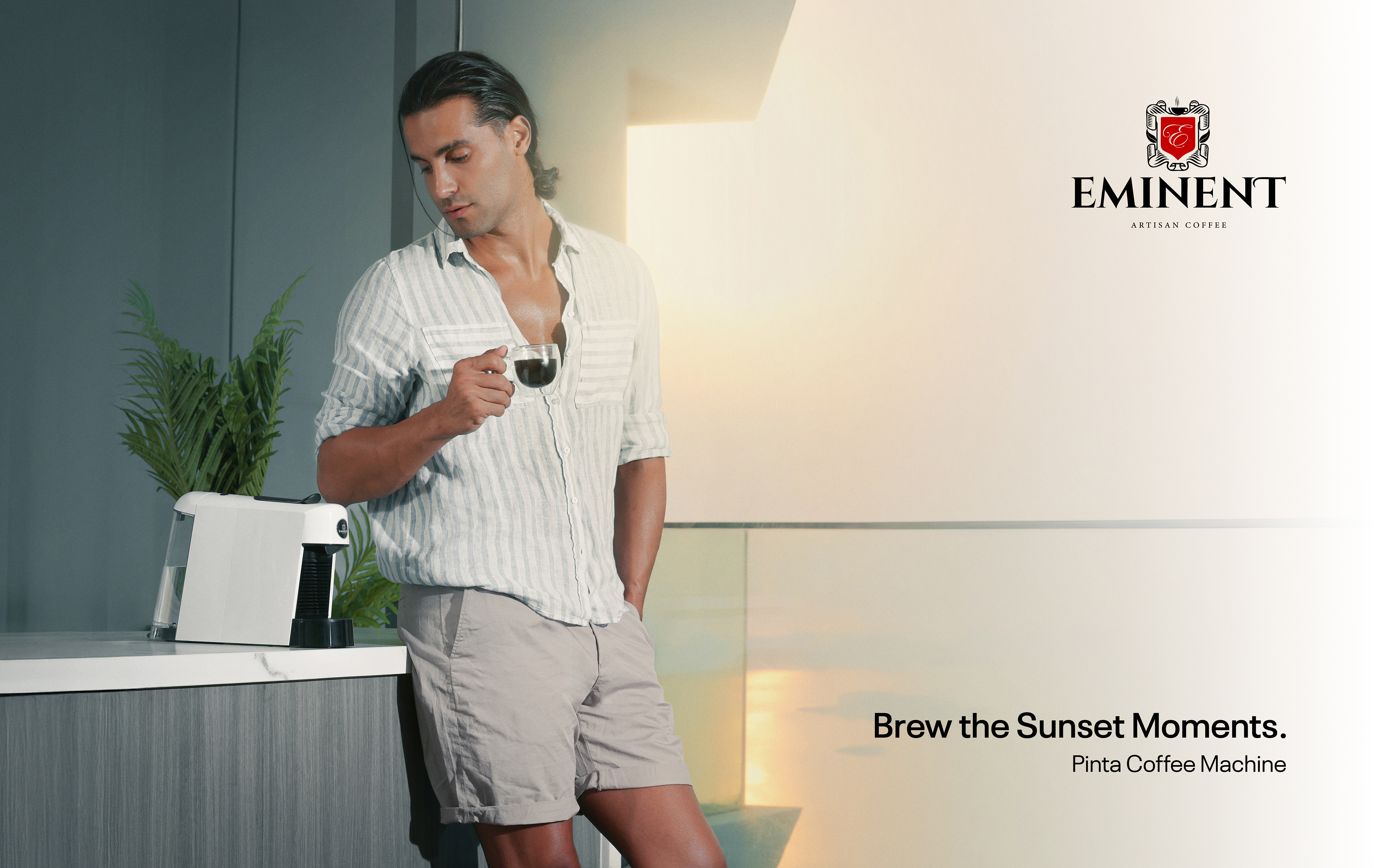 Model with Eminent Pinta coffee machine at sunset.