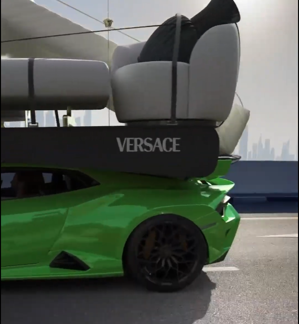 Close-up of Lamborghini carrying Versace Home furniture on a Dubai road.