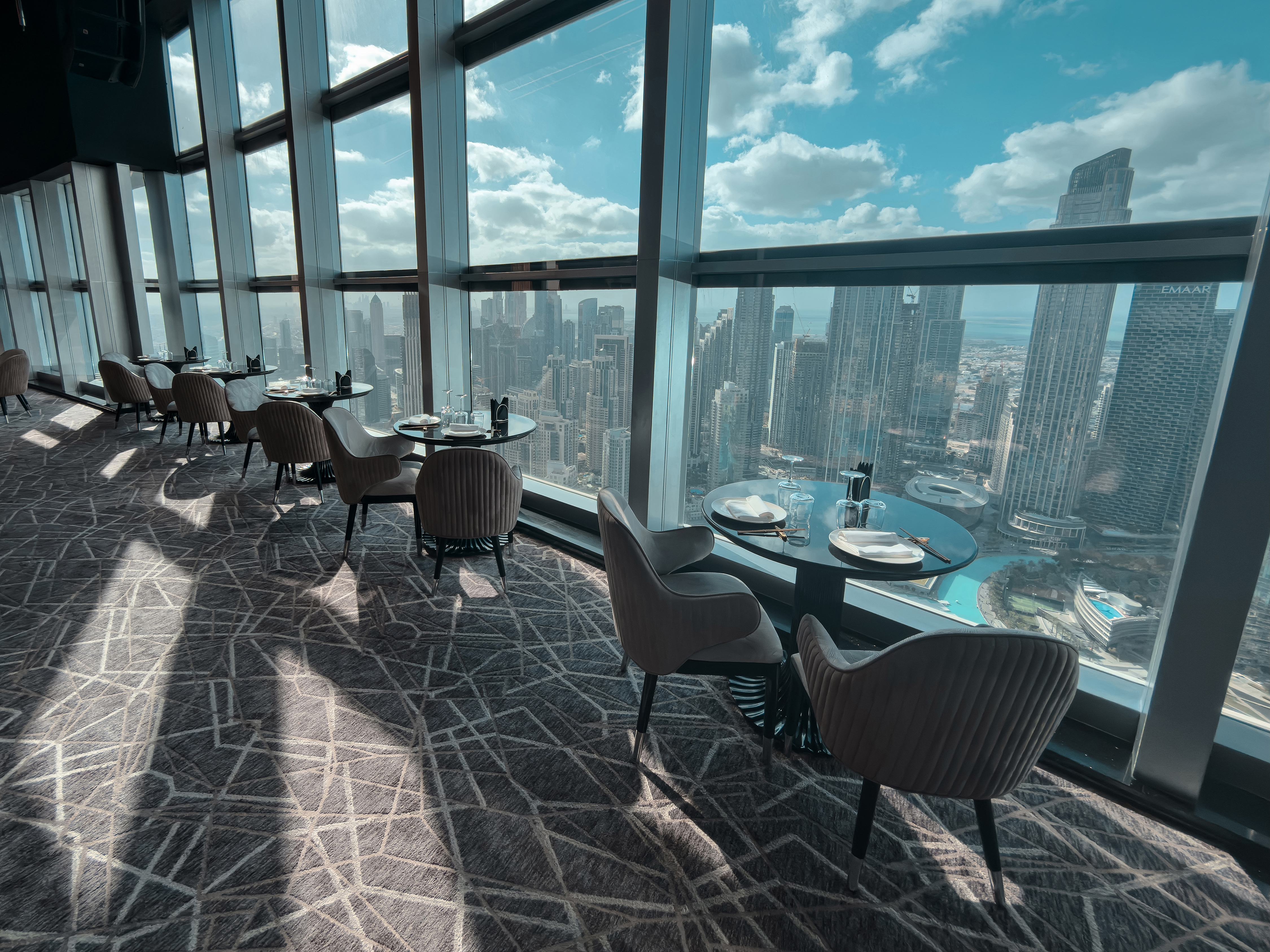 Daylight tables at BIRDS Dubai overlooking Downtown Dubai.