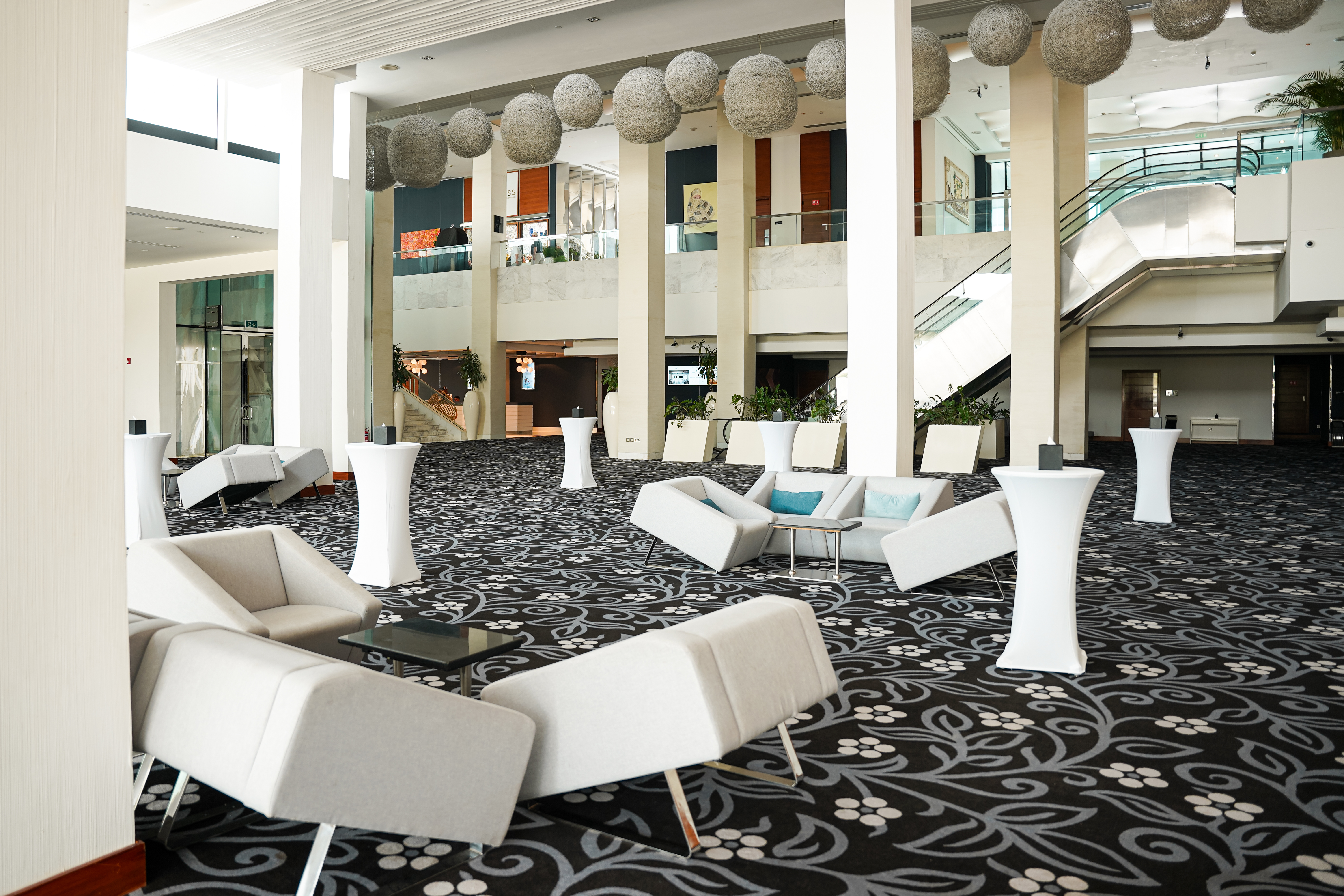 Fairmont Bab Al Bahr pre-function lounge with event cocktail tables.