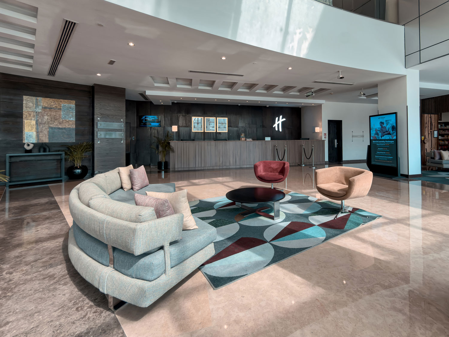 Holiday Inn Abu Dhabi lobby reception and seating area.