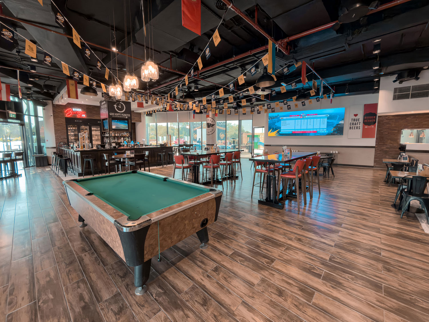 Holiday Inn Abu Dhabi sports bar with pool table and seating.