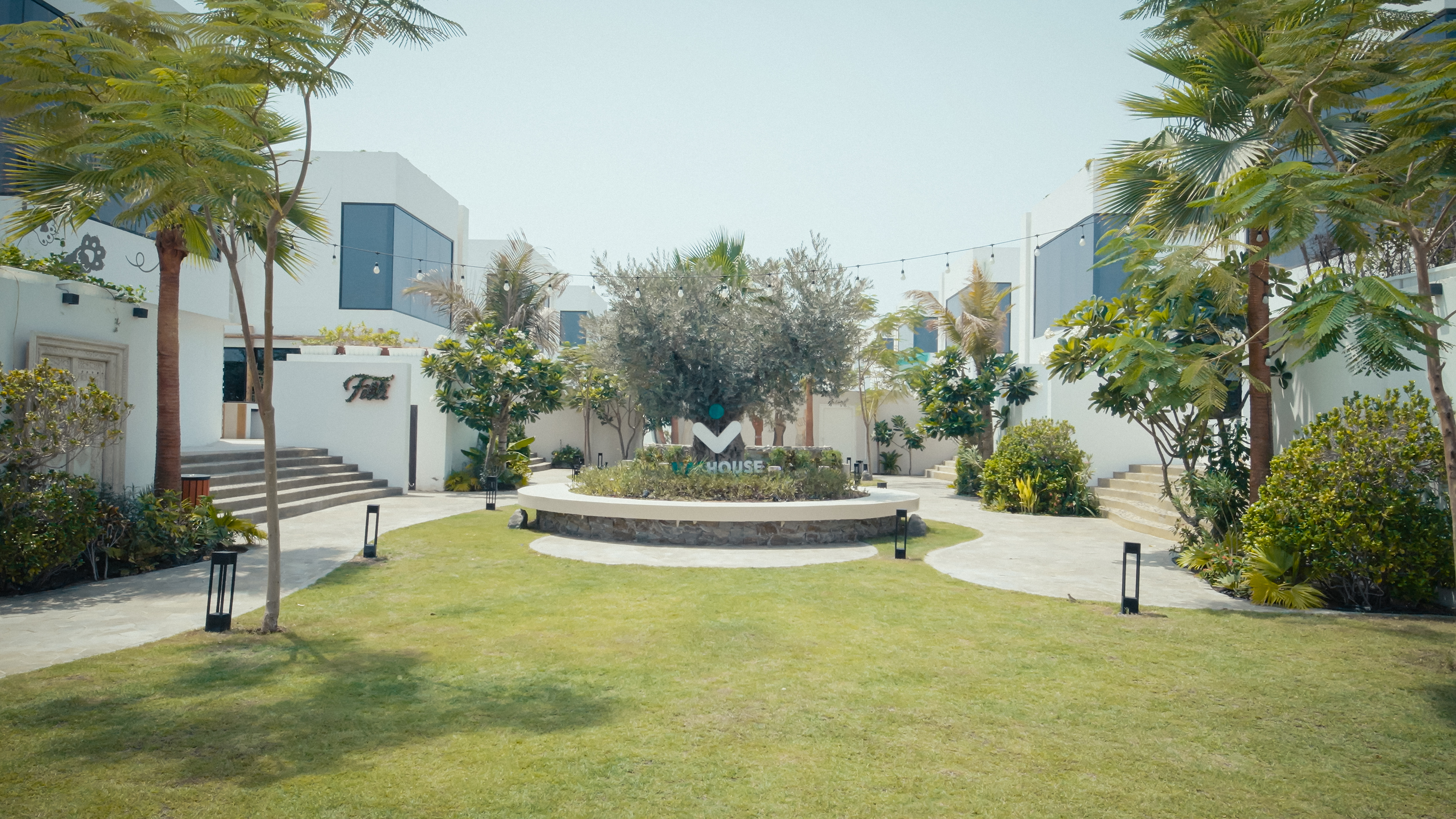 NAS House landscaped central courtyard with logo and surrounding suites.