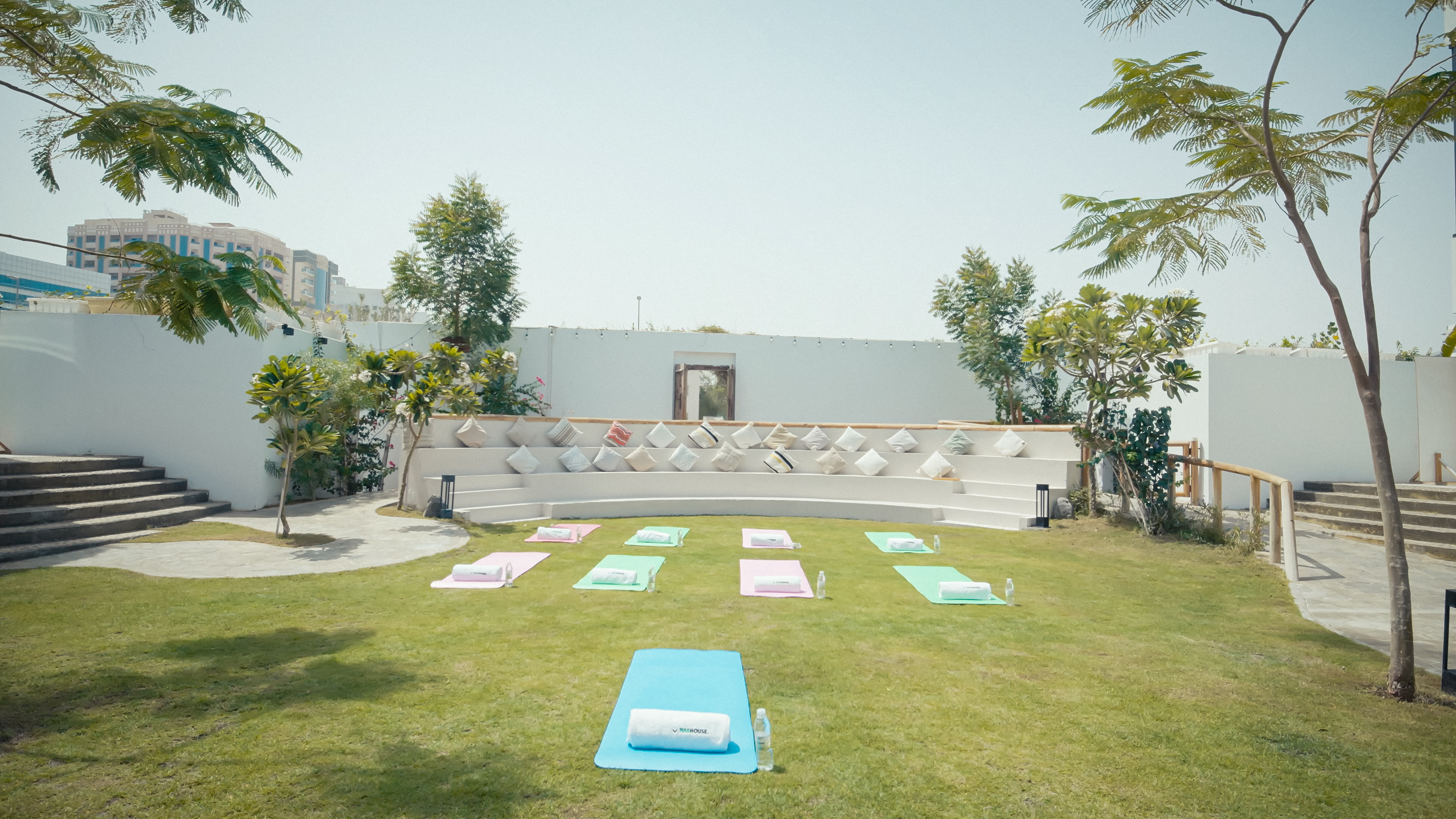 NAS House outdoor lawn prepared with yoga mats.