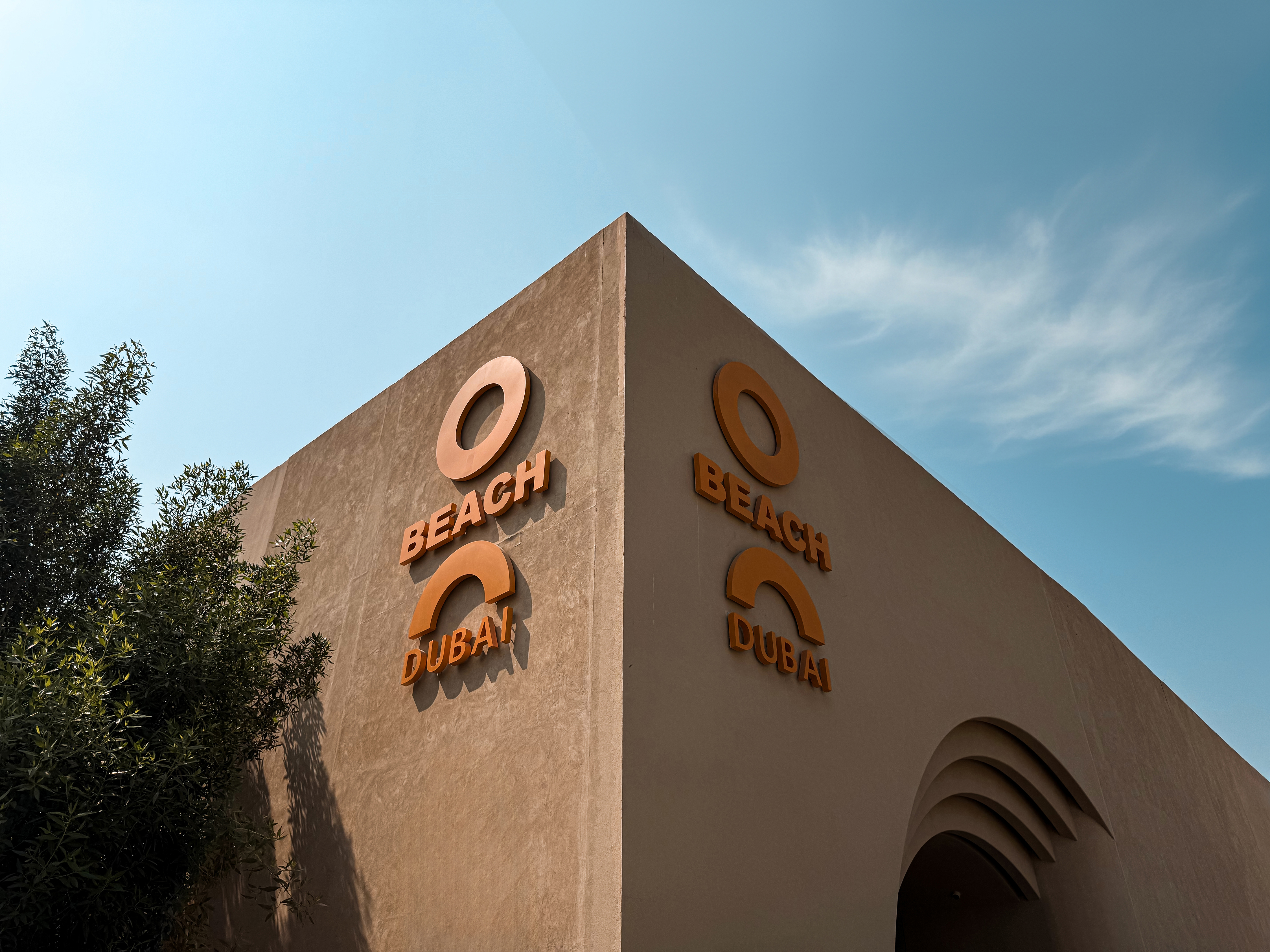O Beach Dubai exterior sign and entrance landscaping.