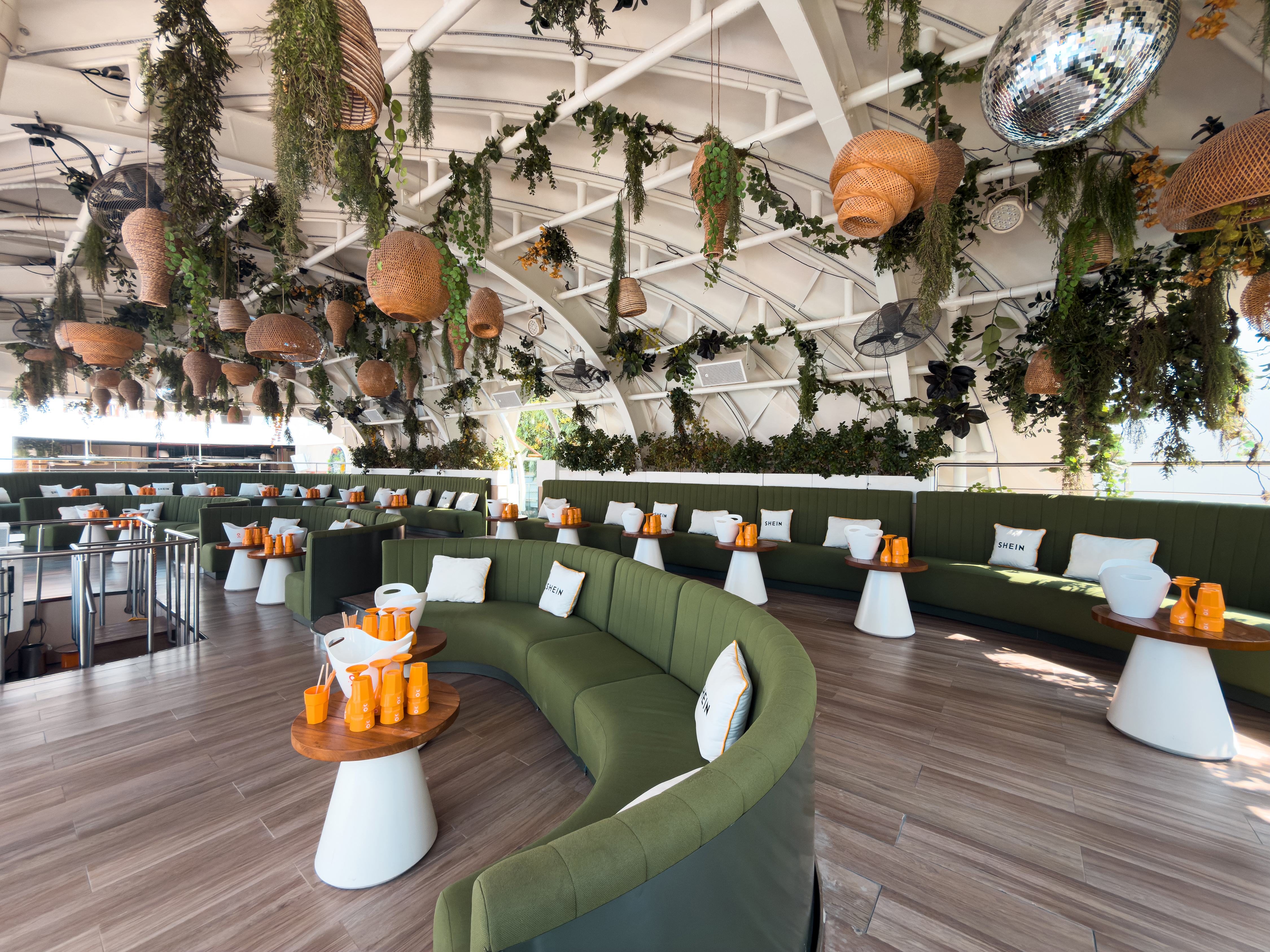 Curved green lounge seating inside O Beach Dubai.