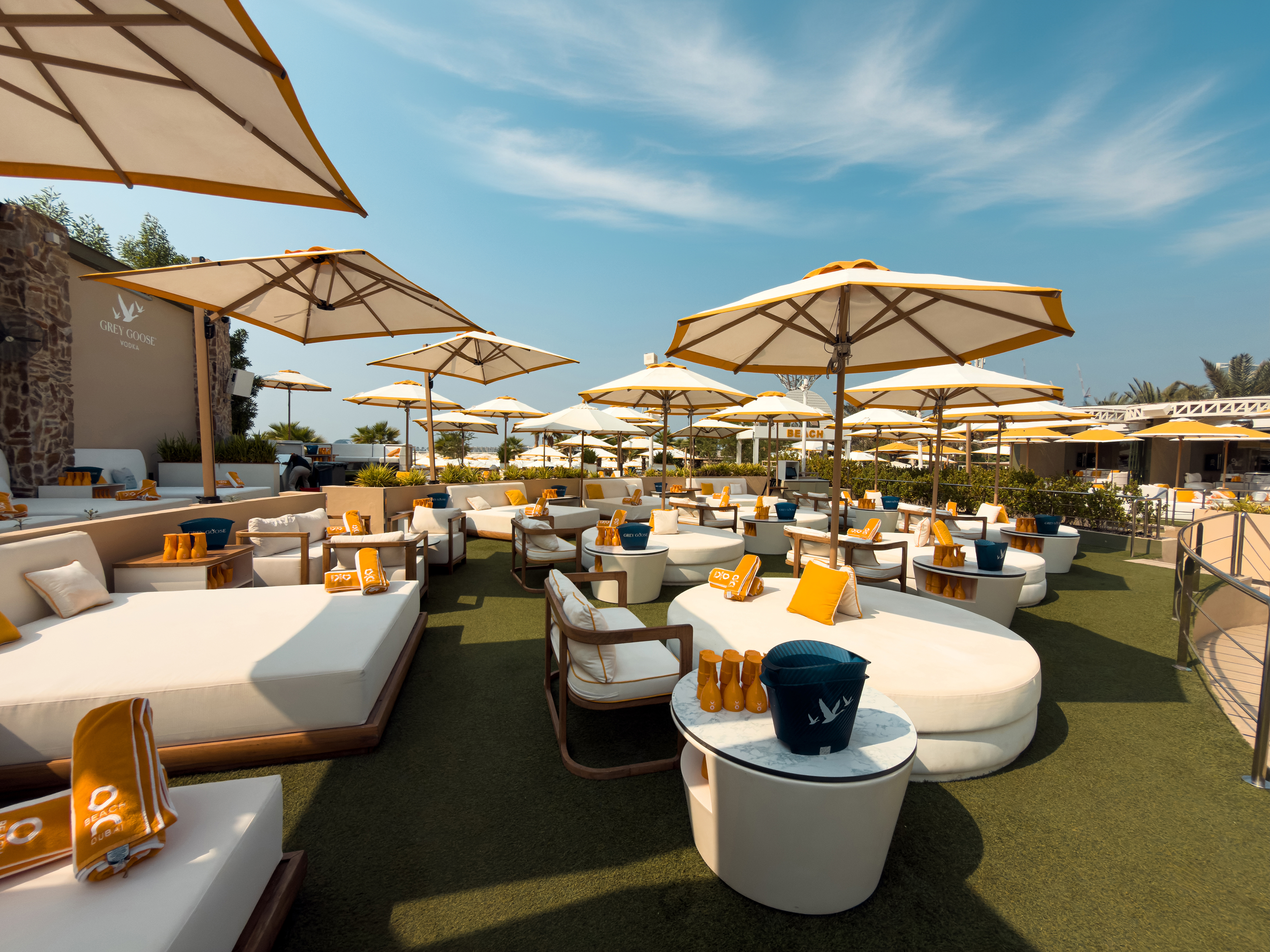 VIP daybeds and umbrellas at O Beach Dubai with skyline views.