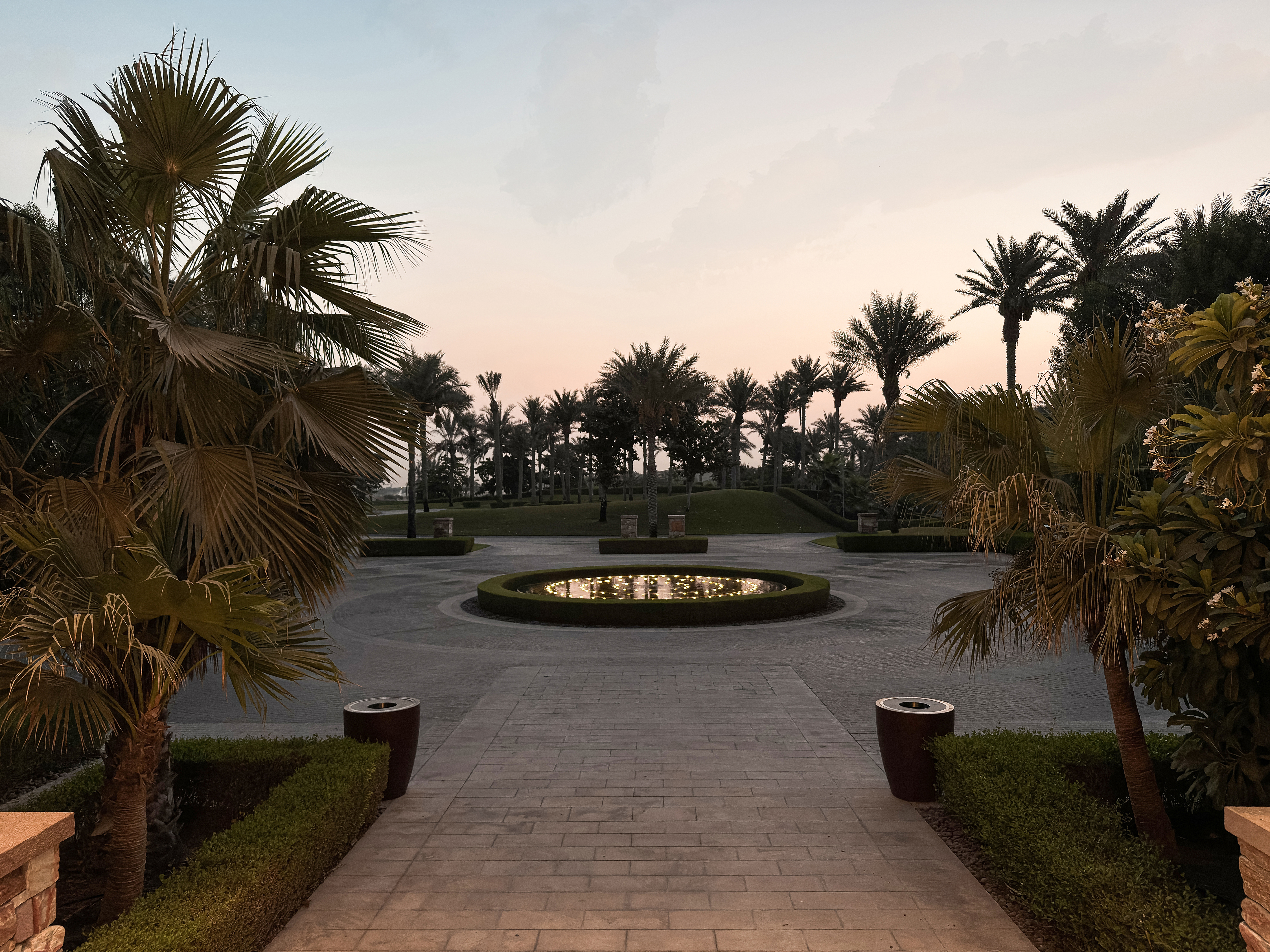 Arrival courtyard with palms and fountain at Saadiyat Beach Golf Club.