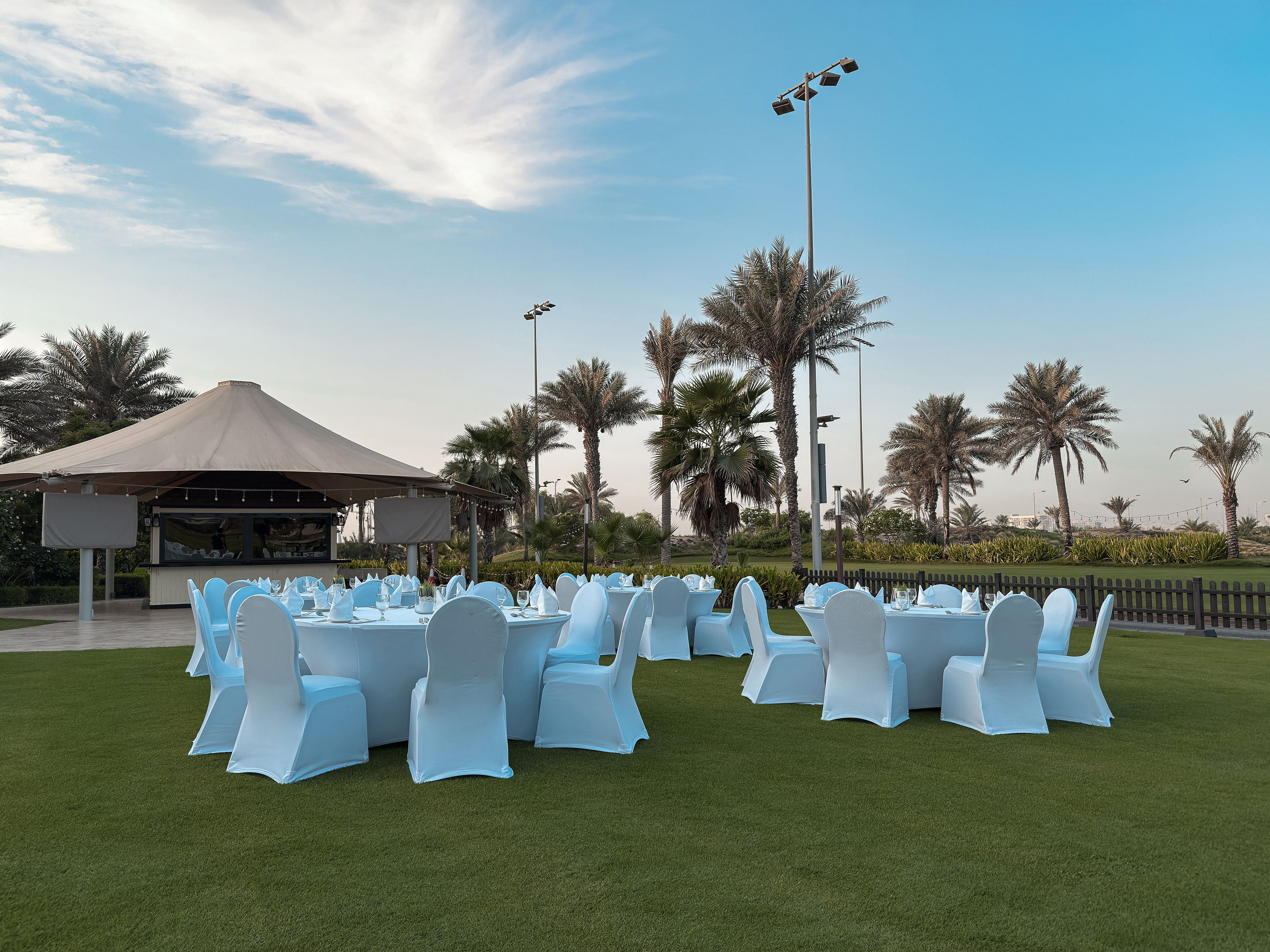 Outdoor lawn event at Saadiyat Beach Golf Club during blue hour.