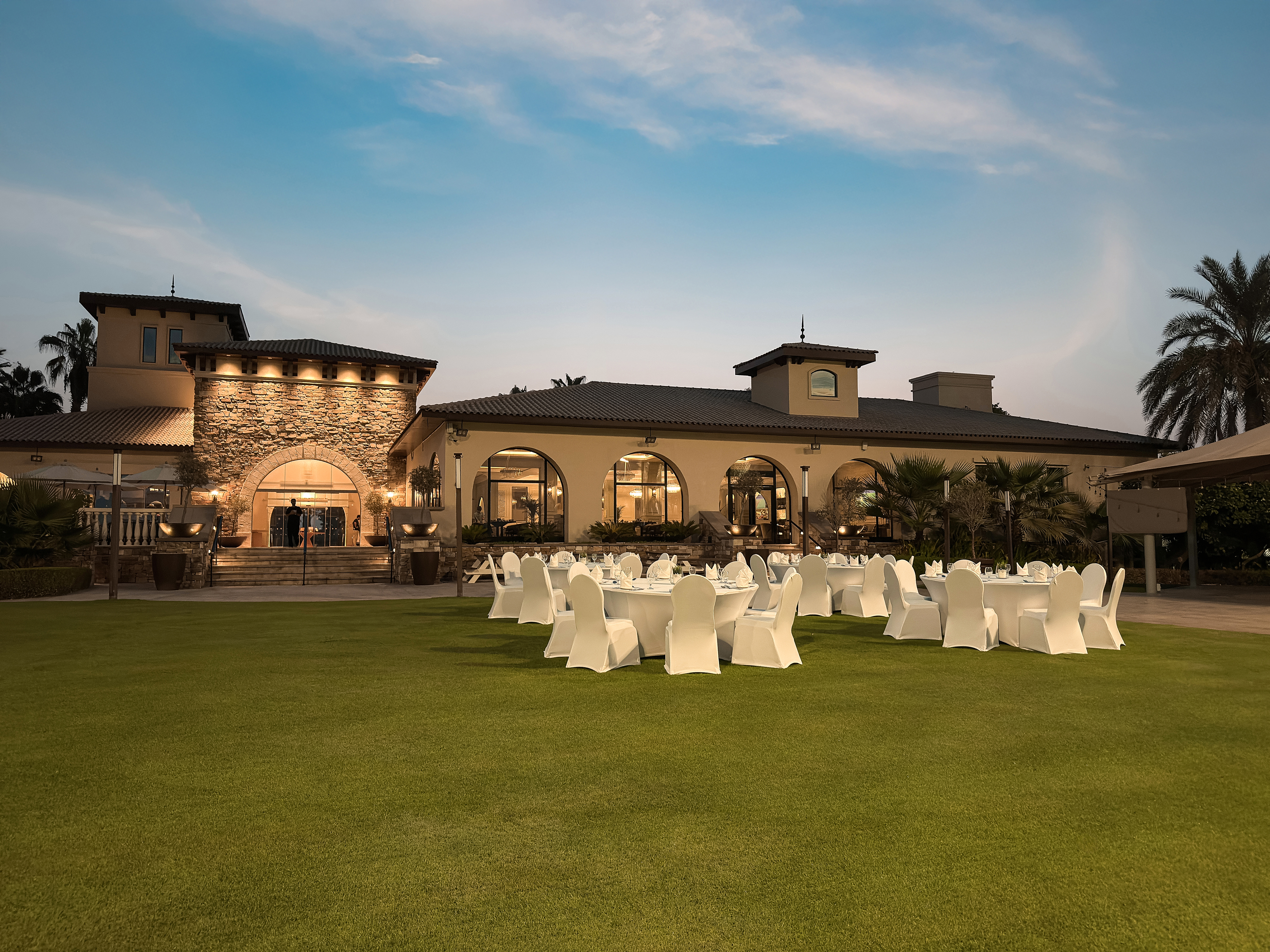 Wide outdoor event setup on the lawn at Saadiyat Beach Golf Club.