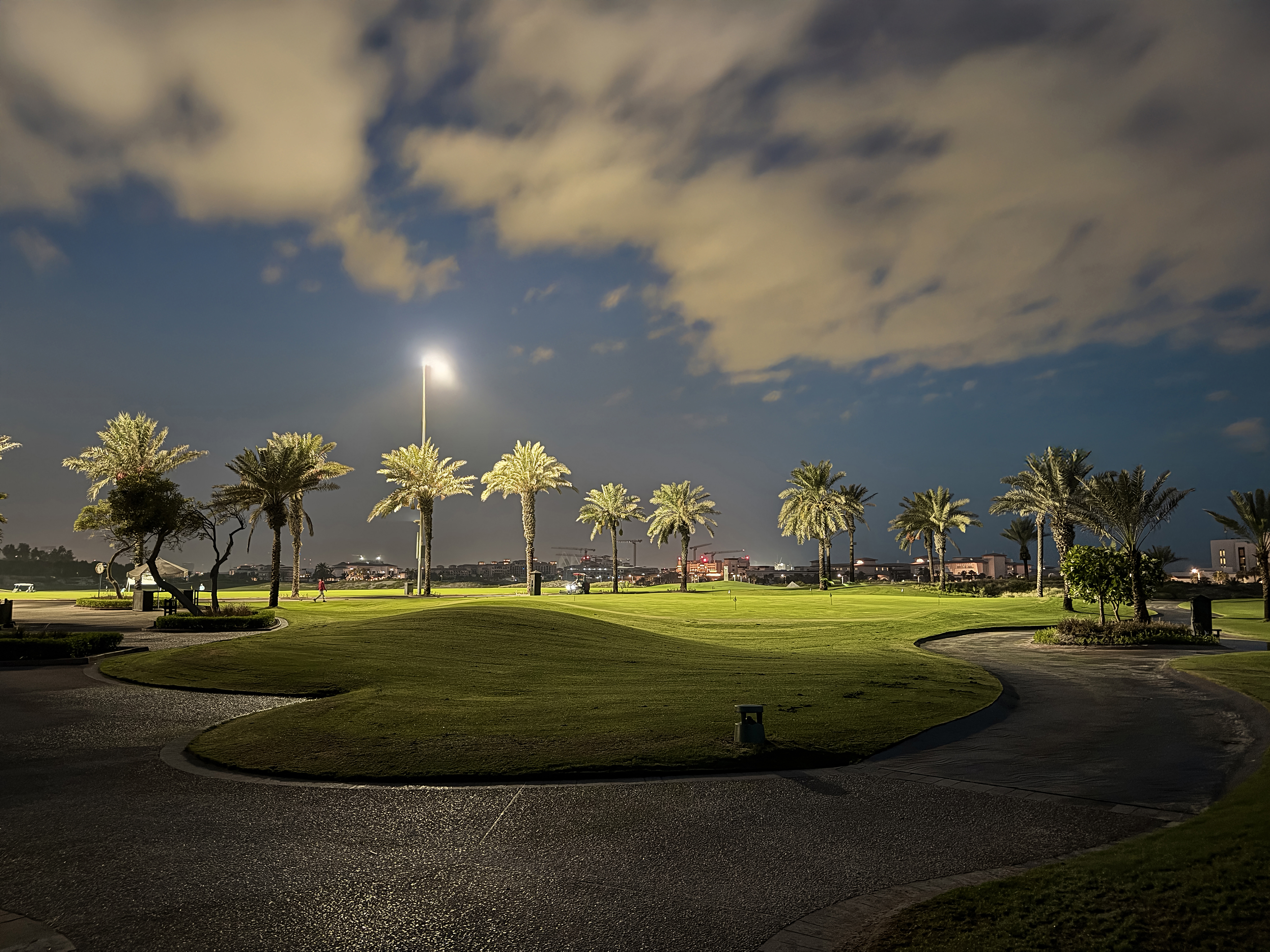 Night view of the illuminated golf course at Saadiyat Beach Golf Club.
