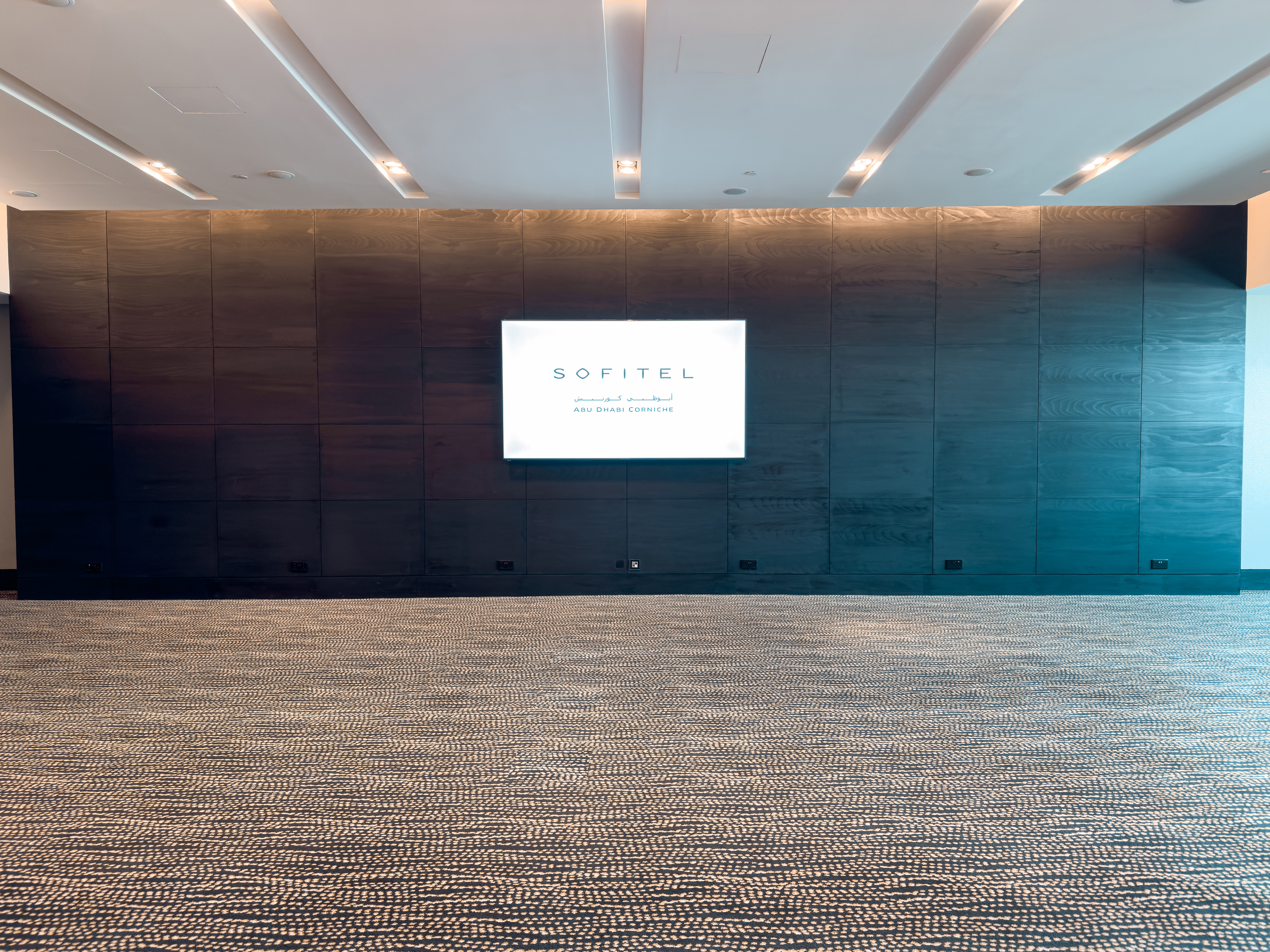 Meeting room with presentation screen at Sofitel Abu Dhabi Corniche.