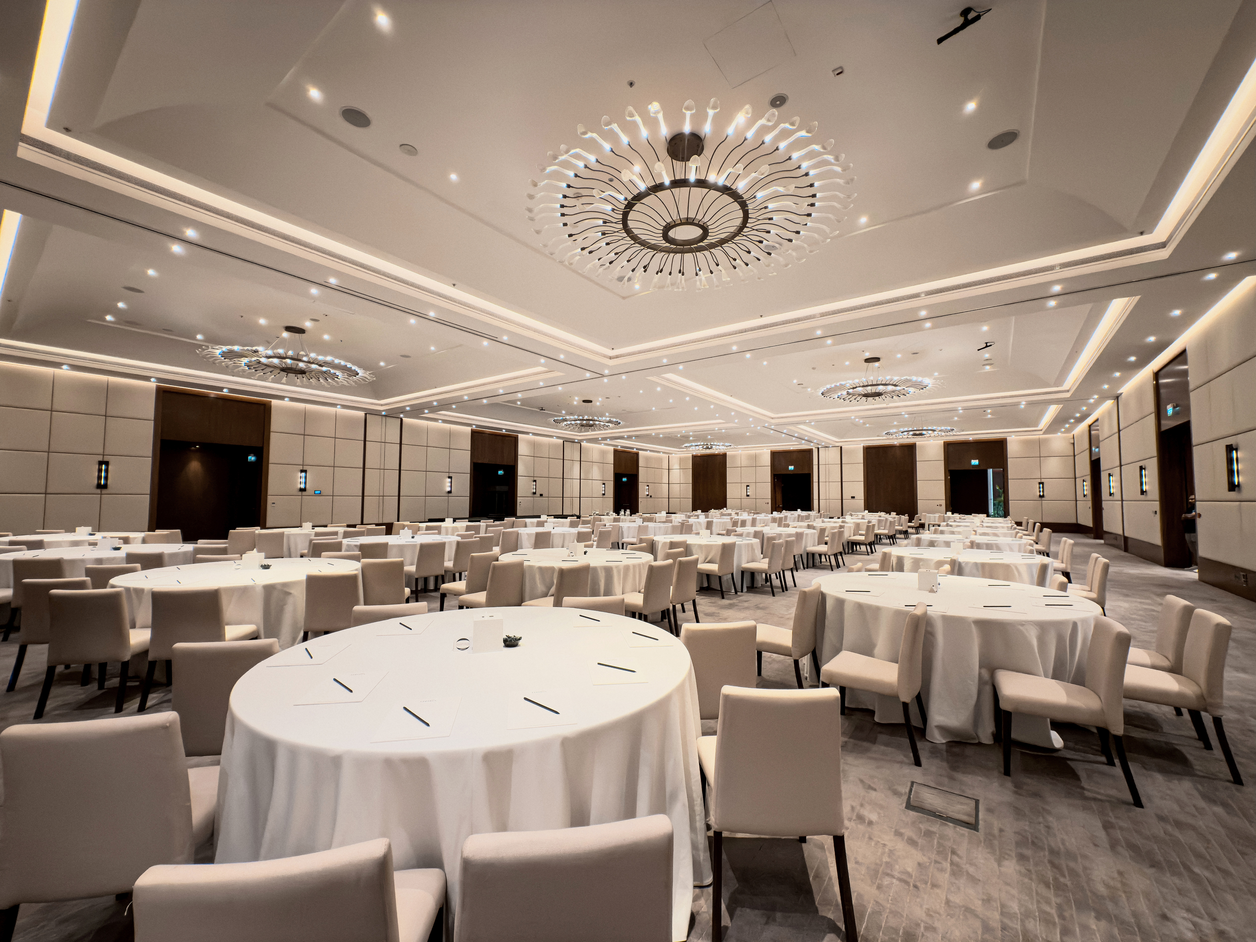 Luxury ballroom at The Abu Dhabi EDITION Hotel arranged for an event.