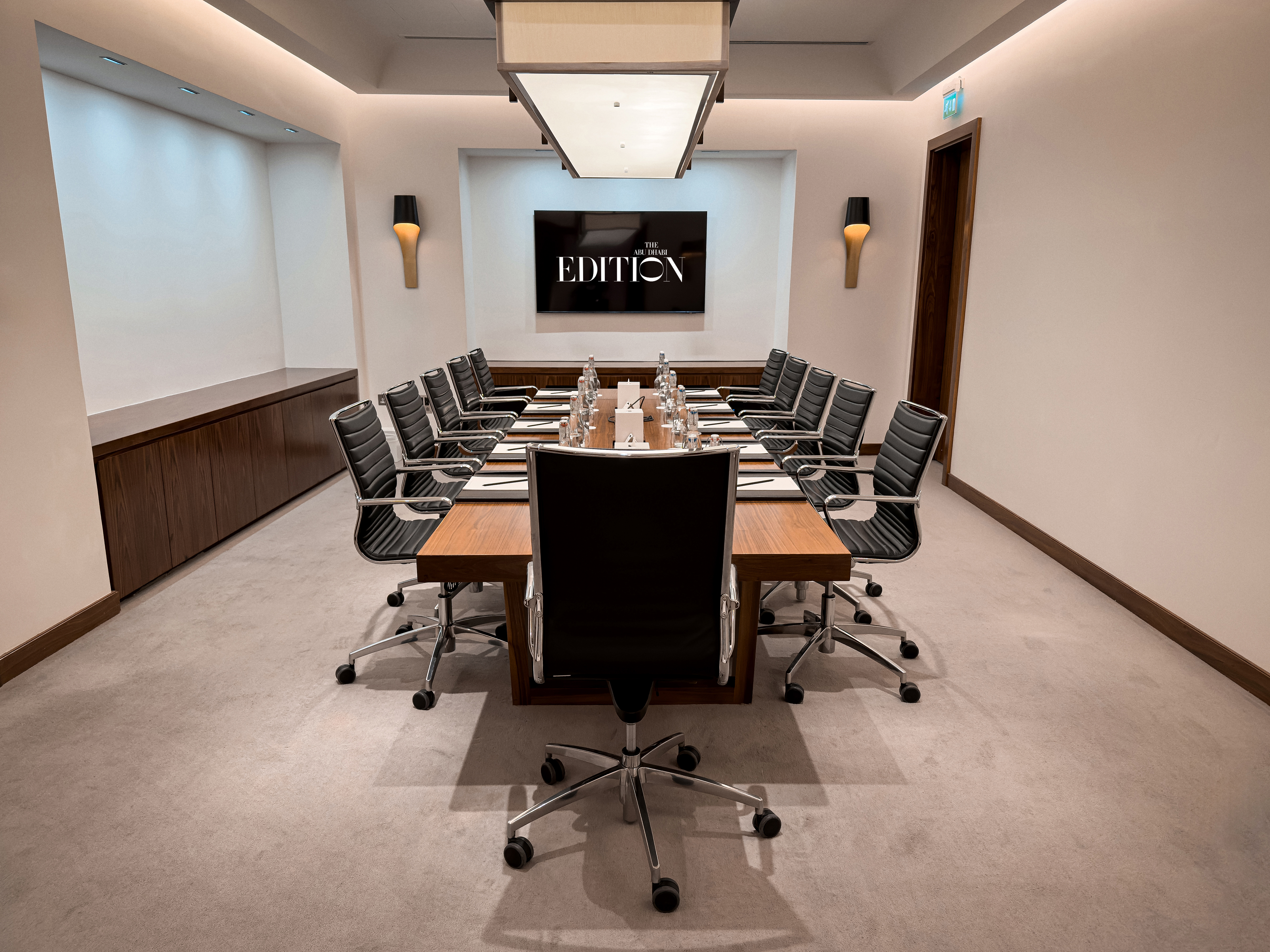 Hotel event lounge with sofas and warm wood walls.